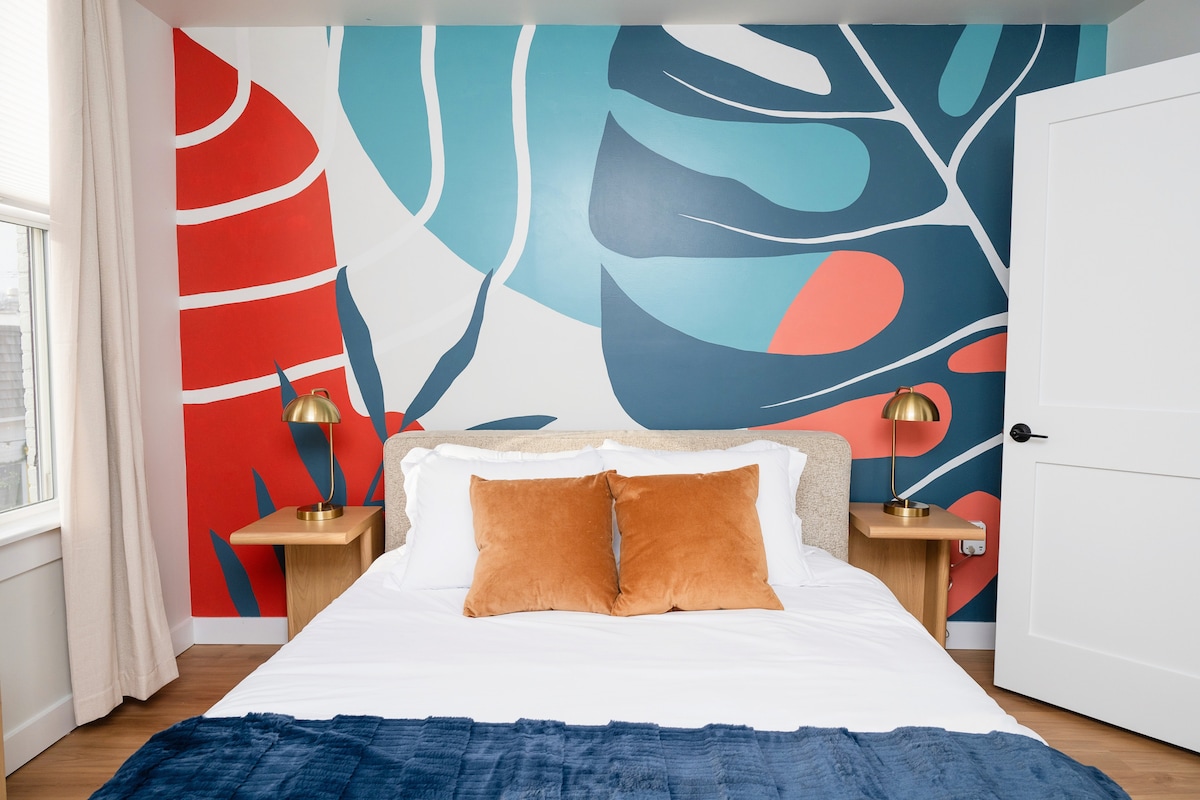 Bedroom with colorful mural accent wall